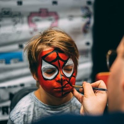 pexels kevin bidwell 2353325 (1) Child getting Spider-Man face paint at event.